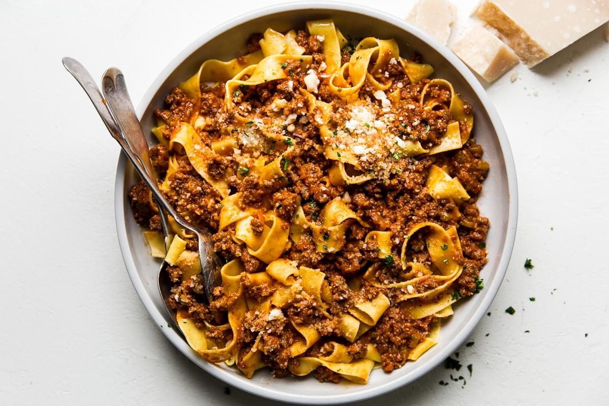 large bowl of easy bolognese with a fork and spoon