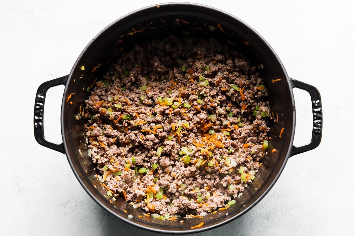 browned ground beef with sauteed vegetables in a pot