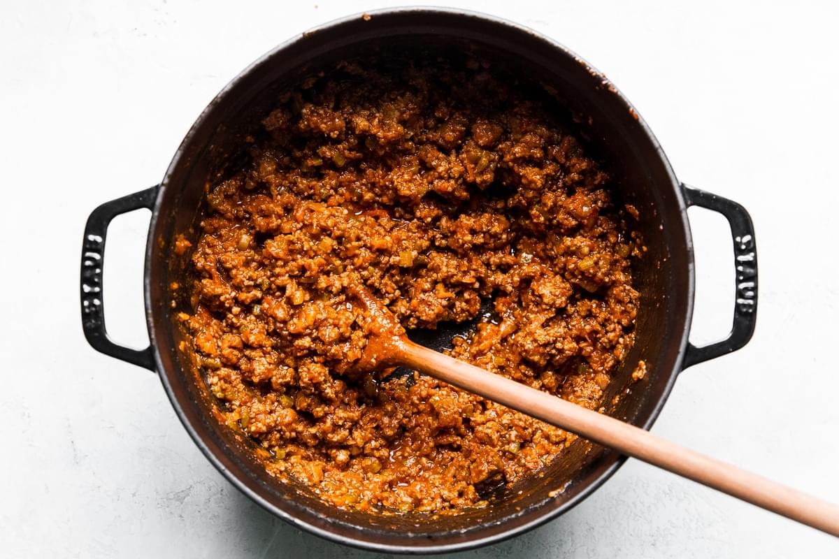 easy homemade bolognese in a pot with a wooden spoon