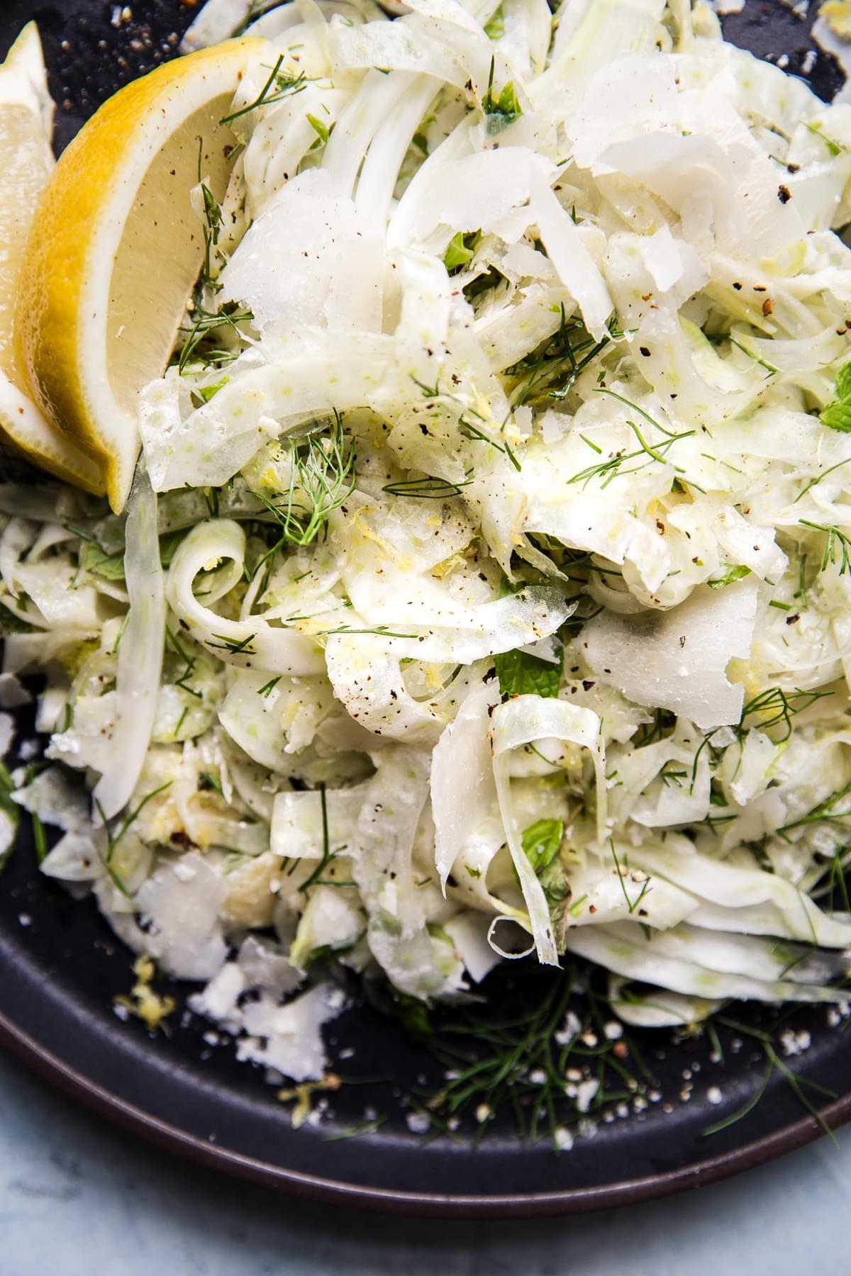 easy shaved fennel salad topped with flaky salt, fresh herbs and parmesan