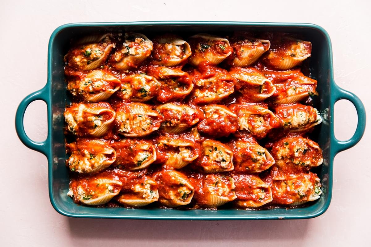 ricotta stuffed pasta shells in a pan with tomato sauce