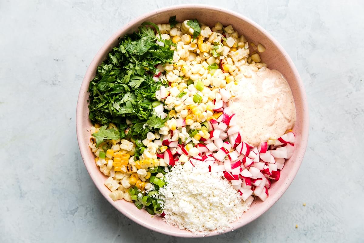 large bowl with chopped up ingredients for Mexican Street Corn Salad