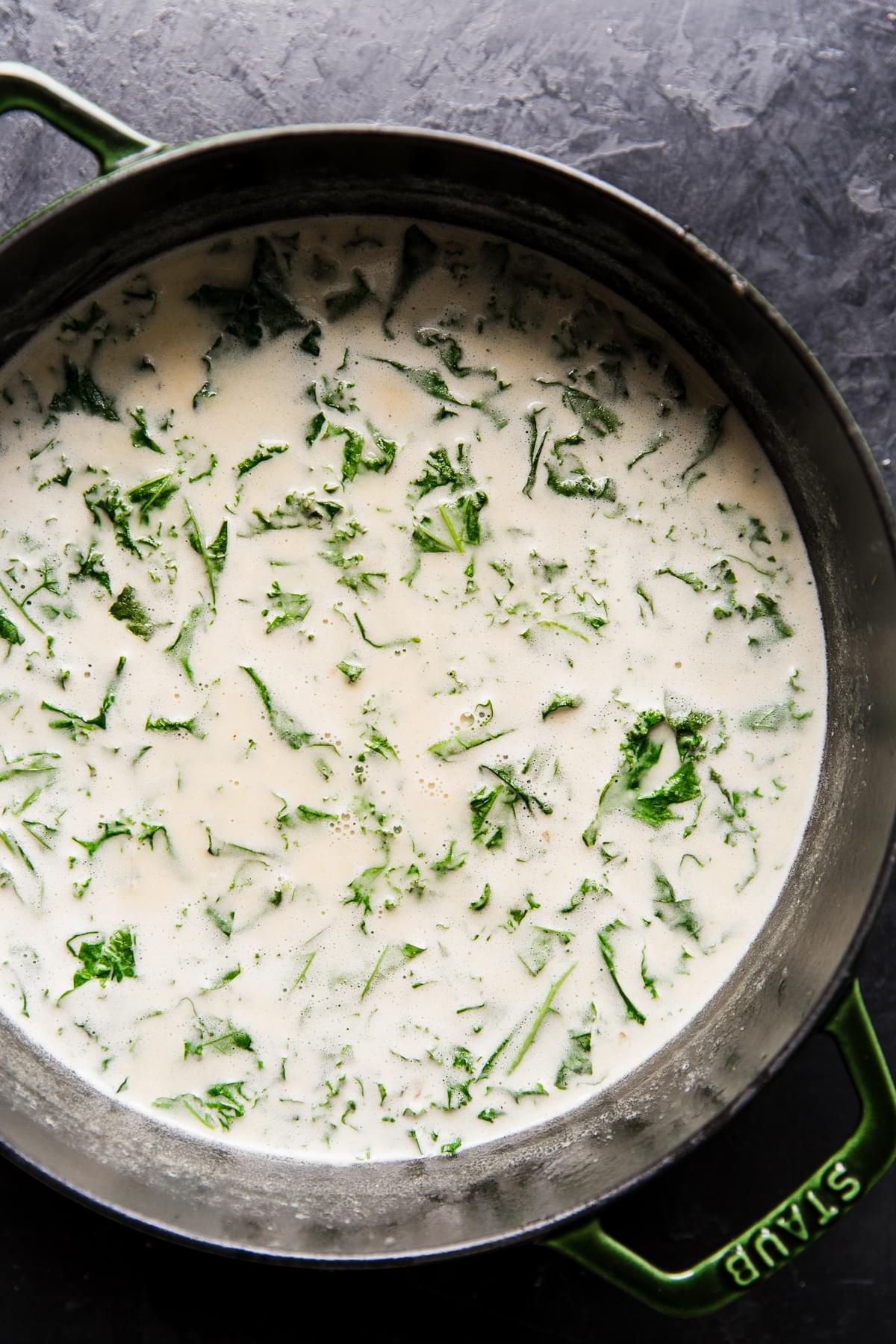 pot of creamy garlic soup with kale