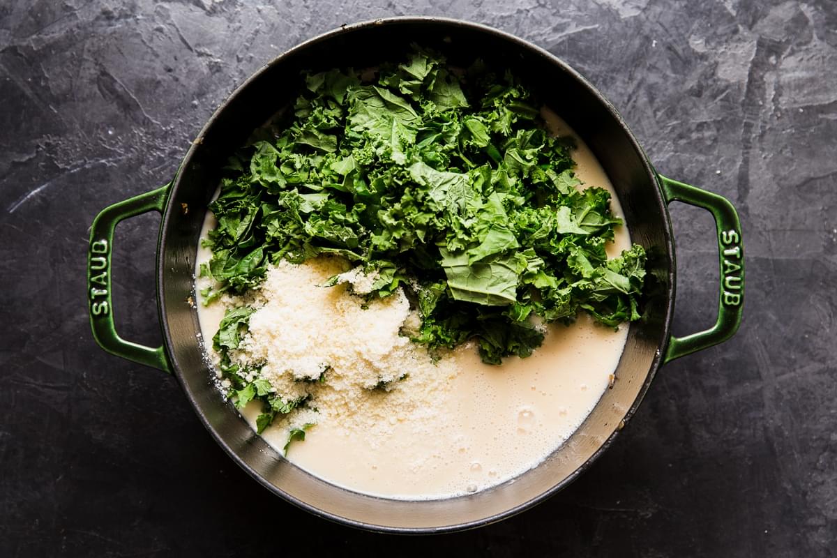 creamy garlic soup with raw kale in a large pot