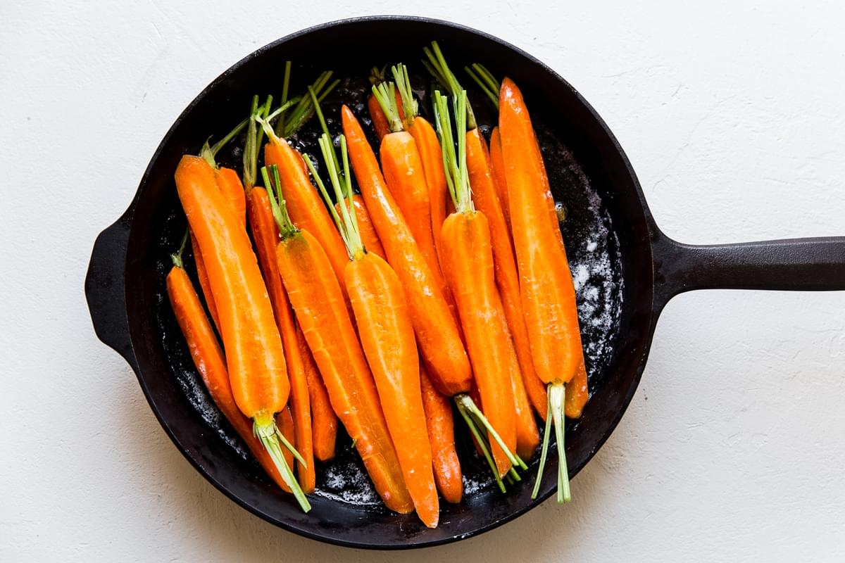 10 carrots halved lengthwise in a cast iron skillet with butter