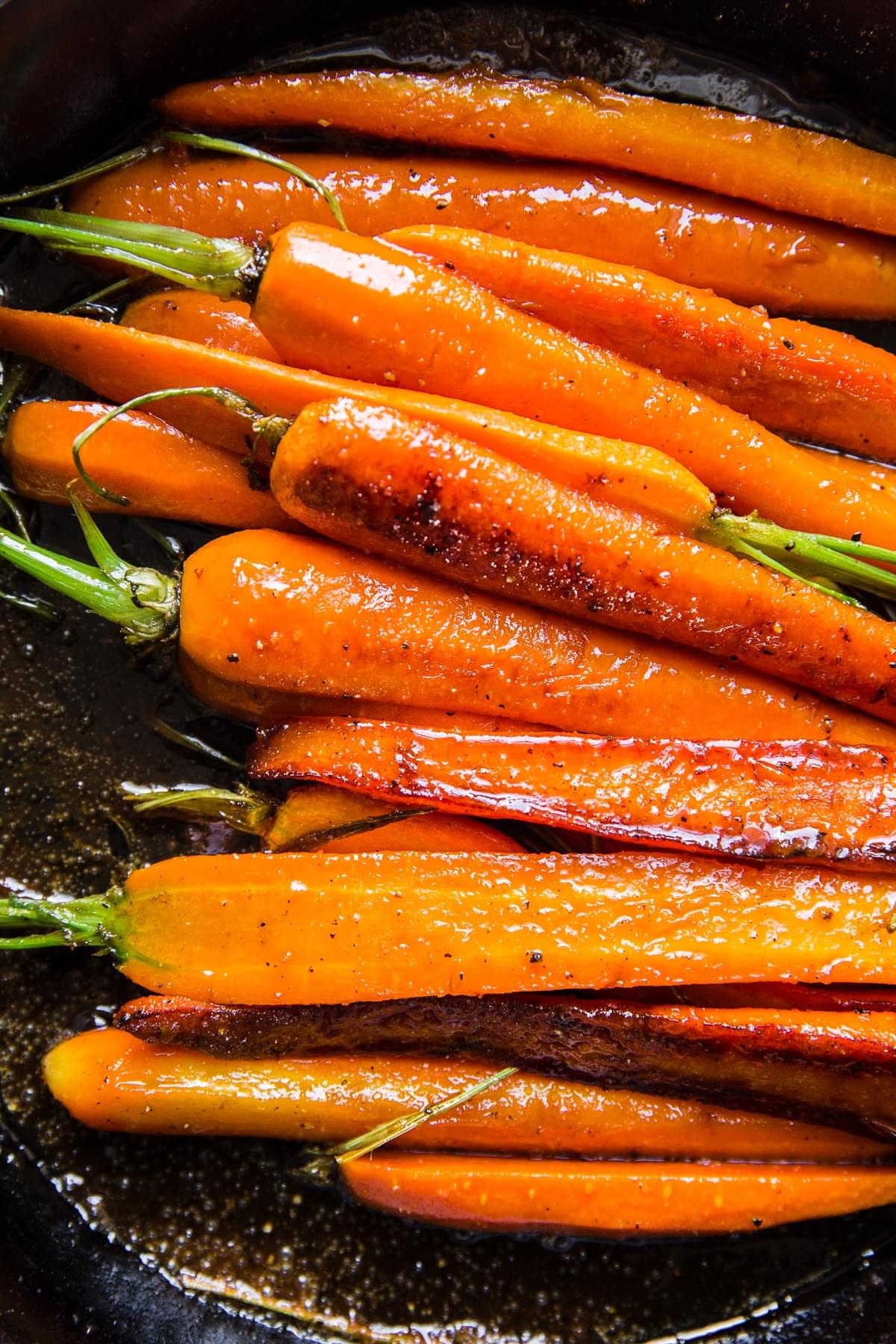 glazed carrots in a cast iron skillet