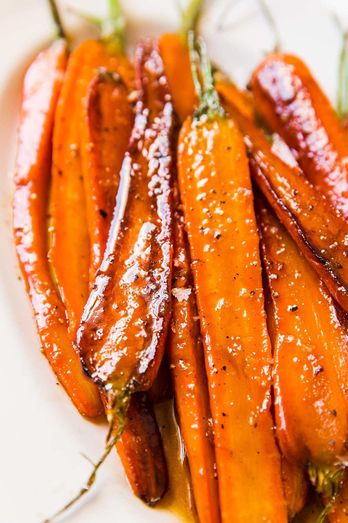 glazed carrots with butter, brown sugar, salt and pepper on a white plate