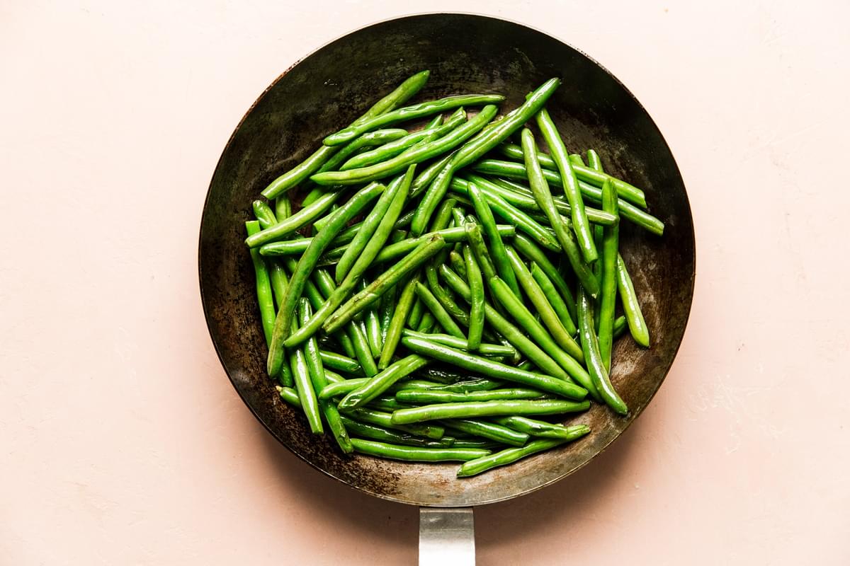1 pound fresh green beans in a skillet with olive oil