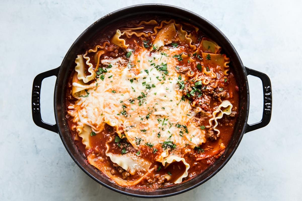 the best lasagna soup in a soup pot with cheese, sausage and ground beef