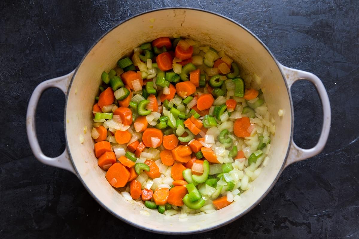 large soup pot with olive oil, carrots, onions and celery