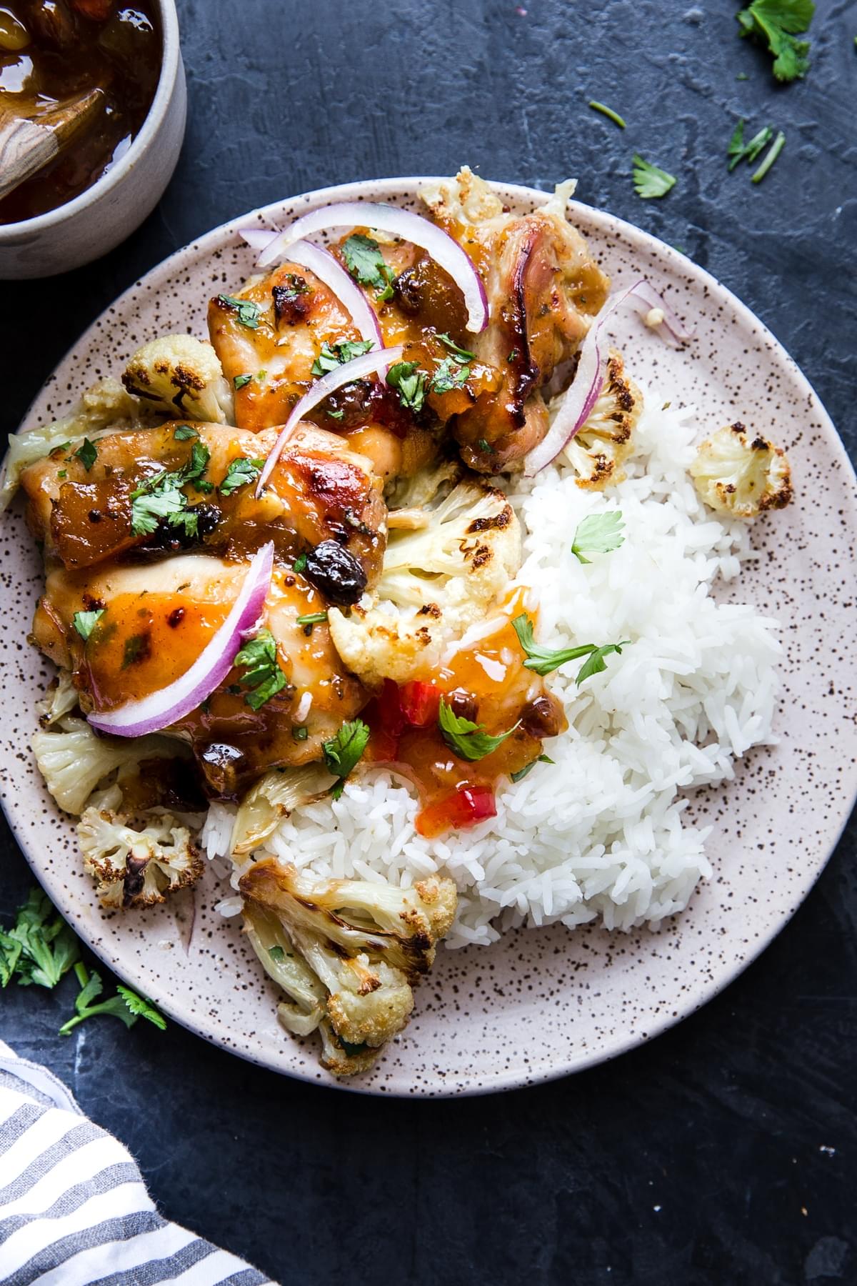 Mango Chutney Sheet Pan Chicken With Cauliflower on a plate with rice