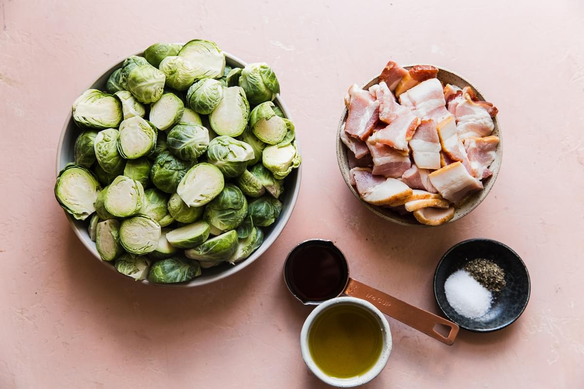 brussels spouts, raw bacon, olive oil, maple syrup, salt and pepper in small bowls to make maple bacon brussels sprouts