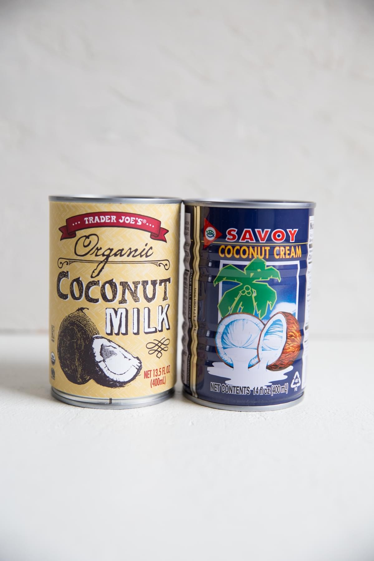 a can of coconut milk next to a can of coconut cream