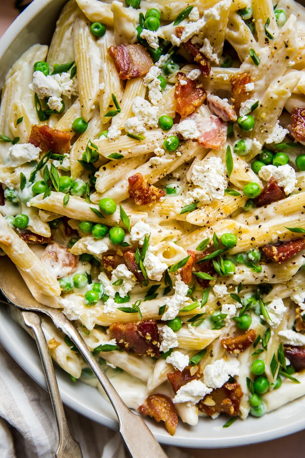close up of Pasta With Peas Pancetta And Goat Cheese and chives