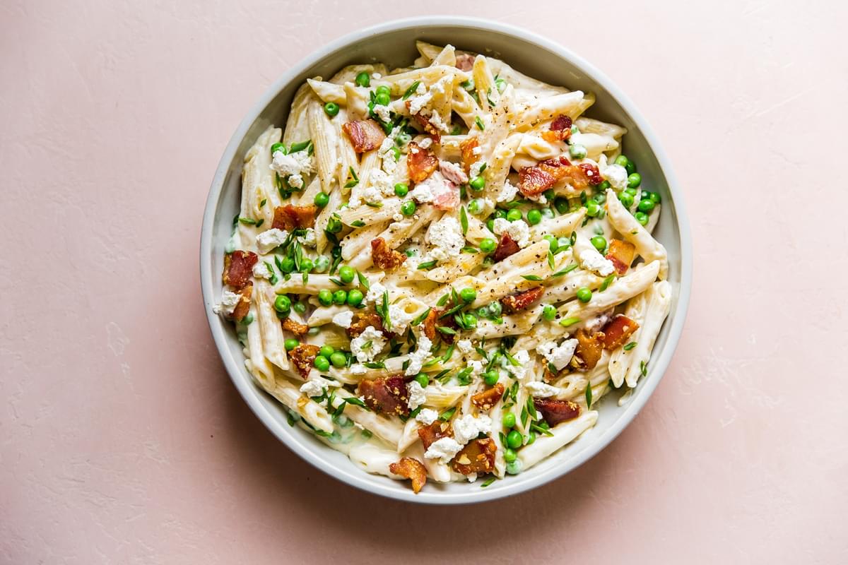 Pasta With Peas Pancetta And Goat Cheese in a serving dish
