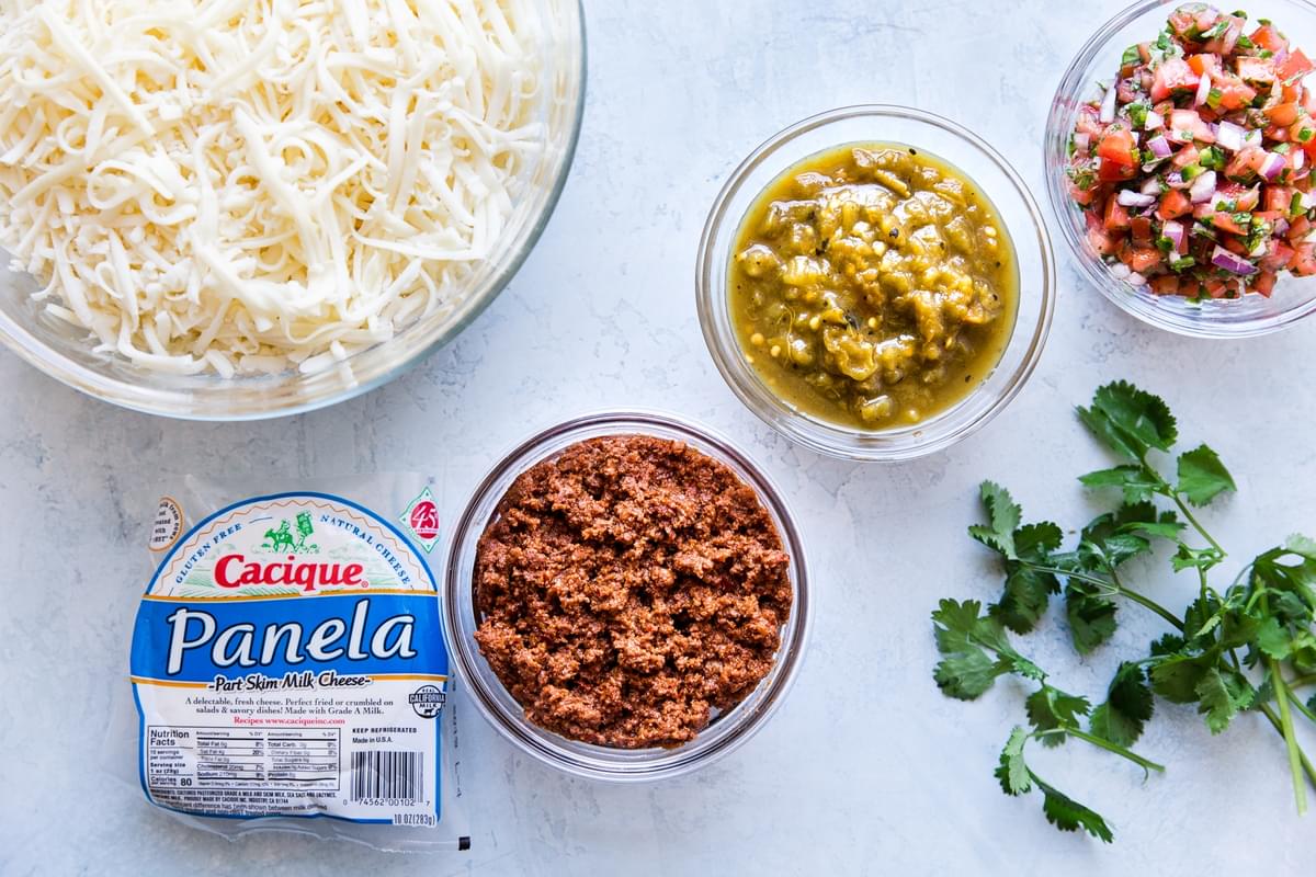 Queso Fundido ingredients mozzarella, panela, chorizo, pico, green chilis and cilantro