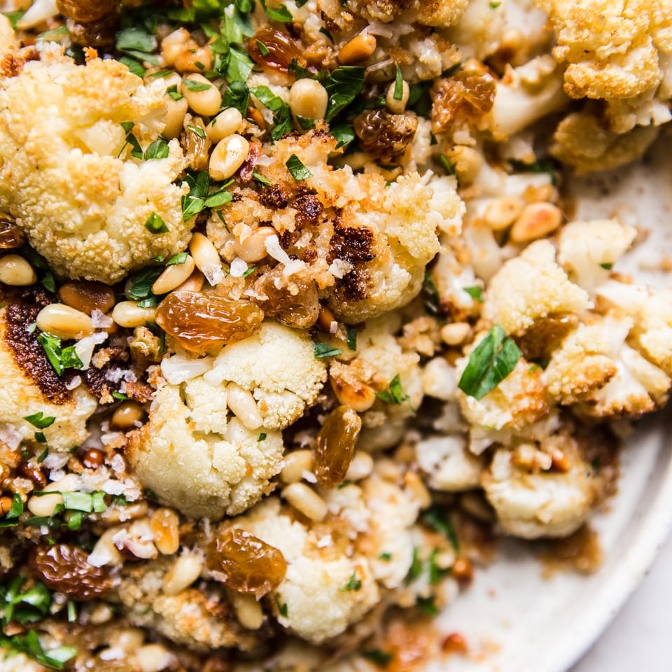 Roasted Cauliflower with Panko and golden raisins and parsley on a plate