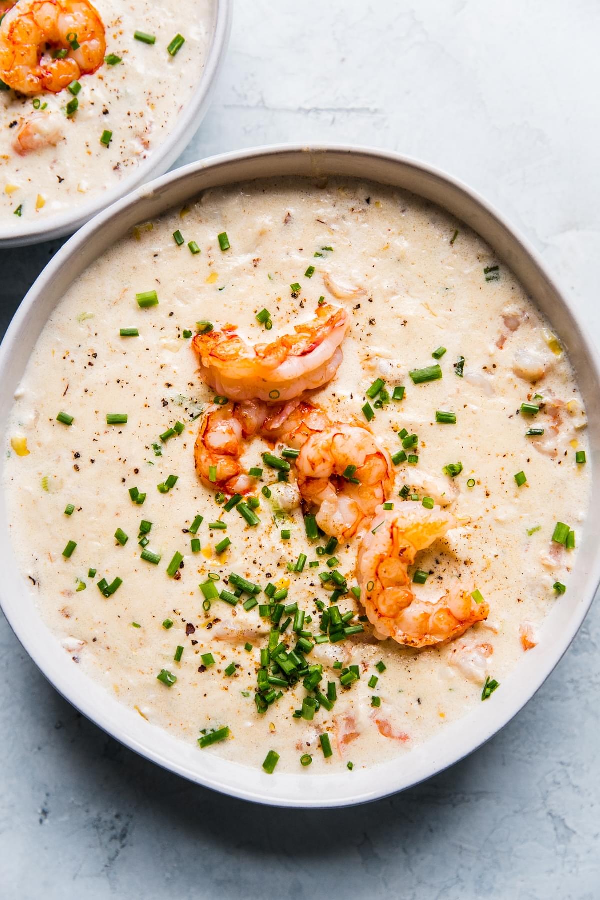 seafood bisque topped with shrimp and chives