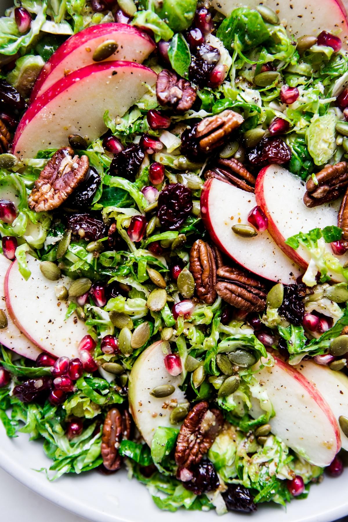Shaved Brussels Sprout Salad with apples, pomegranates, pecans and dried cherries
