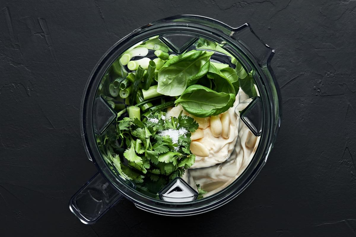 fresh basil leaves, cilantro, green onions, garlic, mayonnaise, lemon juice and salt in a blender