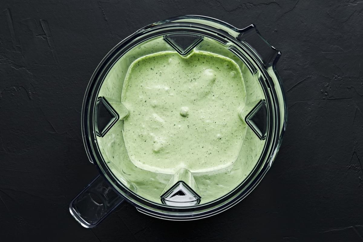 fresh herb sauce in a blender made with fresh Basil leaves, cilantro, green onions, garlic, mayonnaise, lemon juice and salt