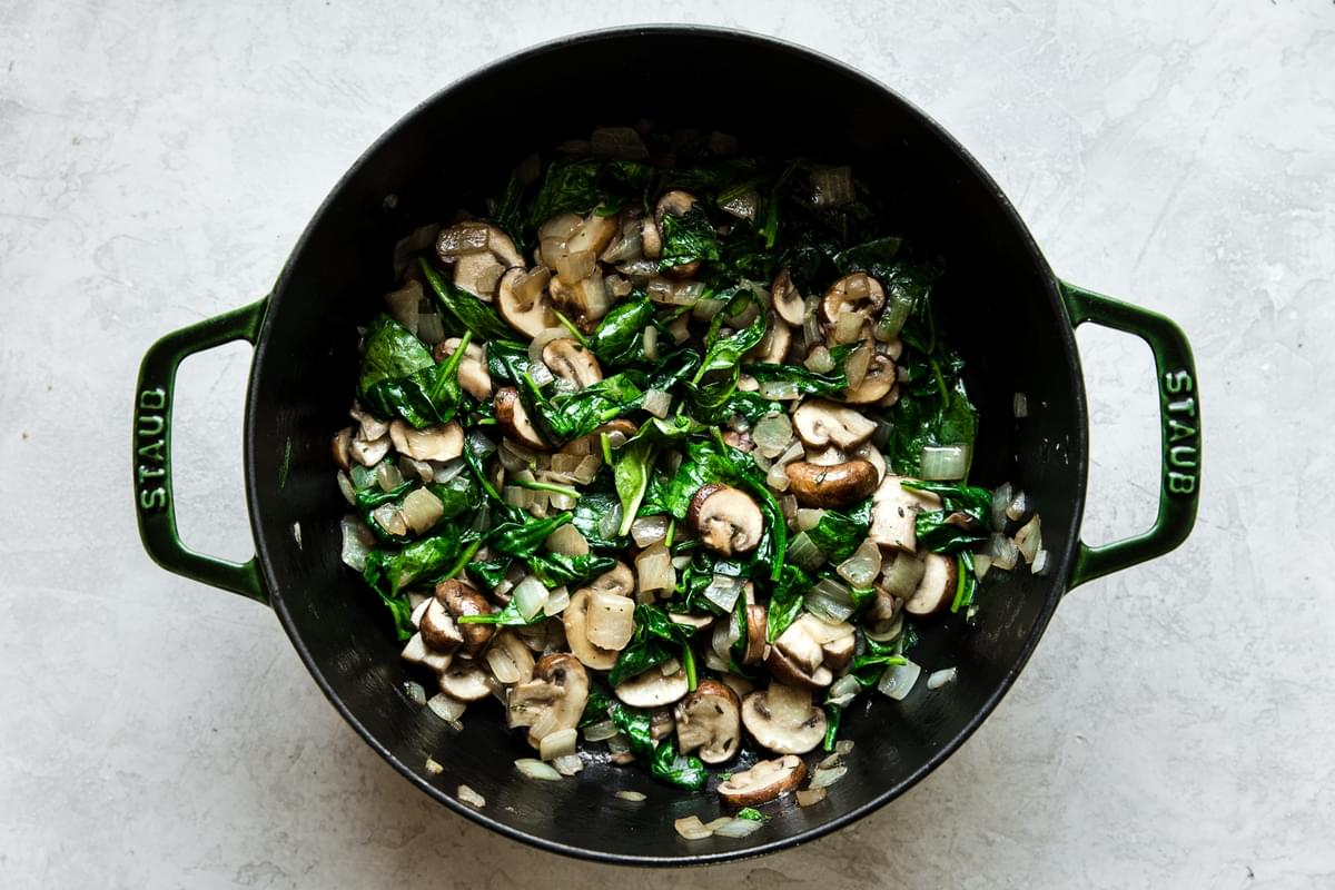 spinach mushroom and onions sauteed in a dutch oven