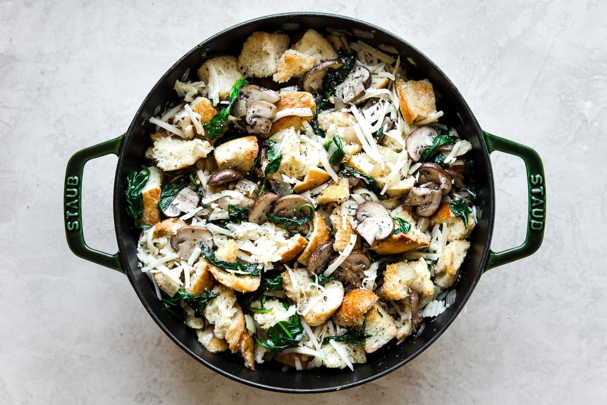 spinach mushroom strata with bread and cheese in a dutch oven