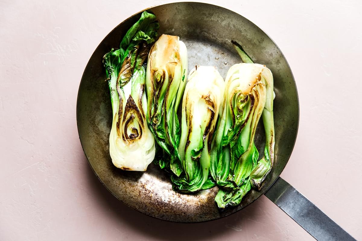 baby bok choy browned in stainless steel skillet