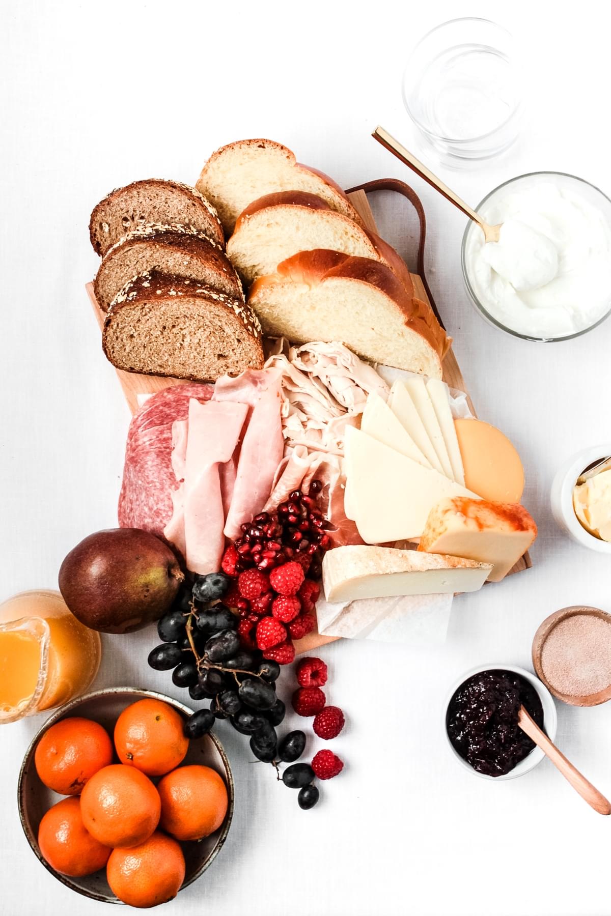 thanksgiving breakfast platter European style with cheese, bread, sliced meats, yogurt and fresh fruit
