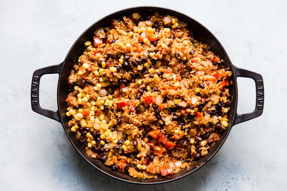 mexican rice with beans and corn in a cast iron skillet