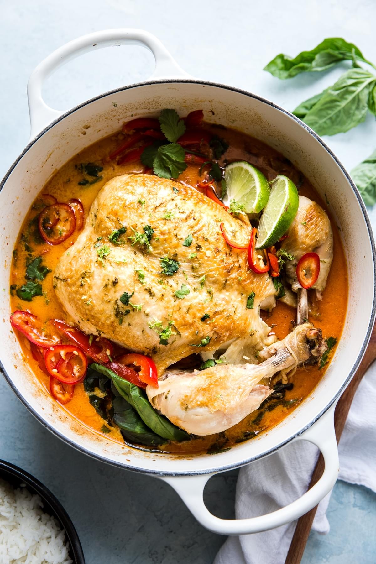 Whole Poached Chicken In Coconut Curry with limes, basil, onions and red bell peppers