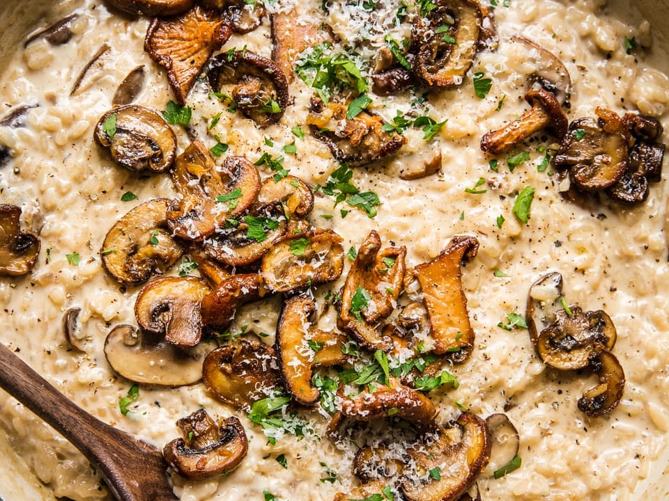 wild mushroom risotto in a large braiser skillet