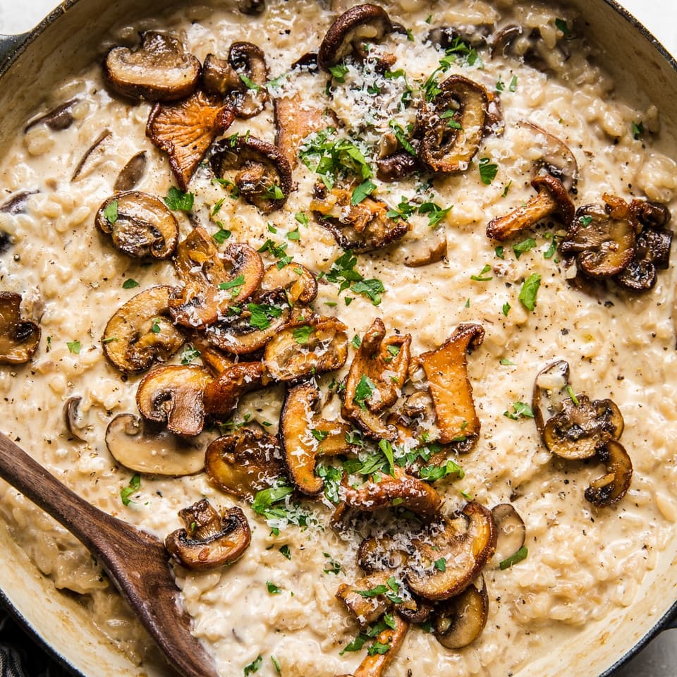 wild mushroom risotto in a large braiser skillet