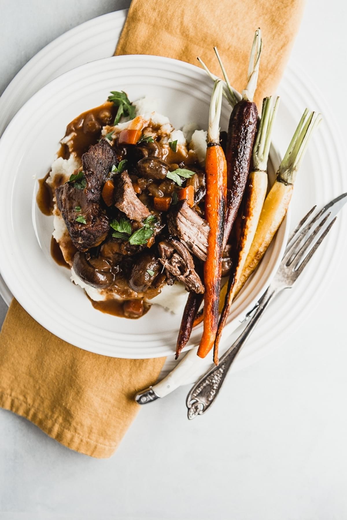 Wine Braised Beef With Mushrooms served with mashed potatoes and carrots