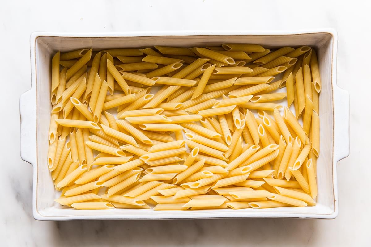 Dry penne in a baking pan