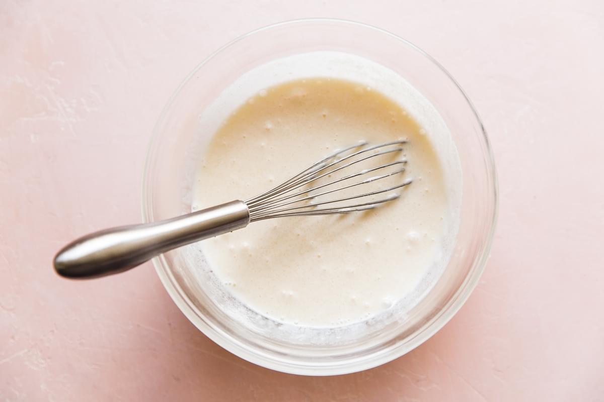 sweet creamy salad dressing in a bowl with a whisk