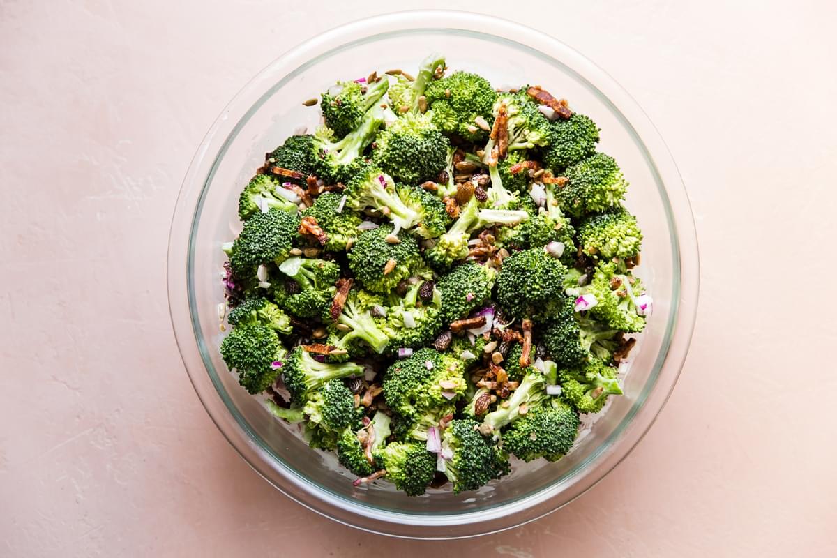 homemade broccoli salad with creamy sweet dressing, crispy bacon, golden raisins and purple onion