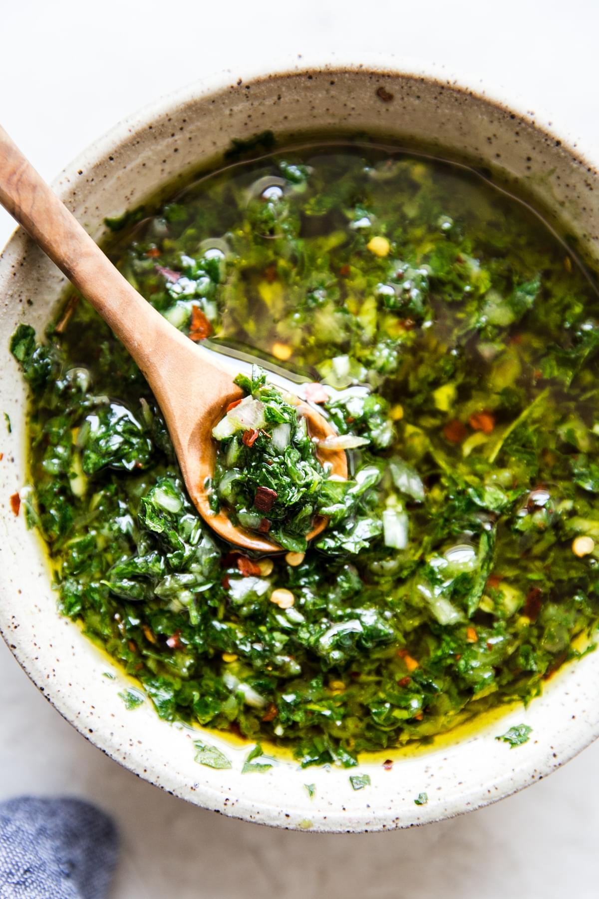 homemade chimichurri in a bowl with a spoon