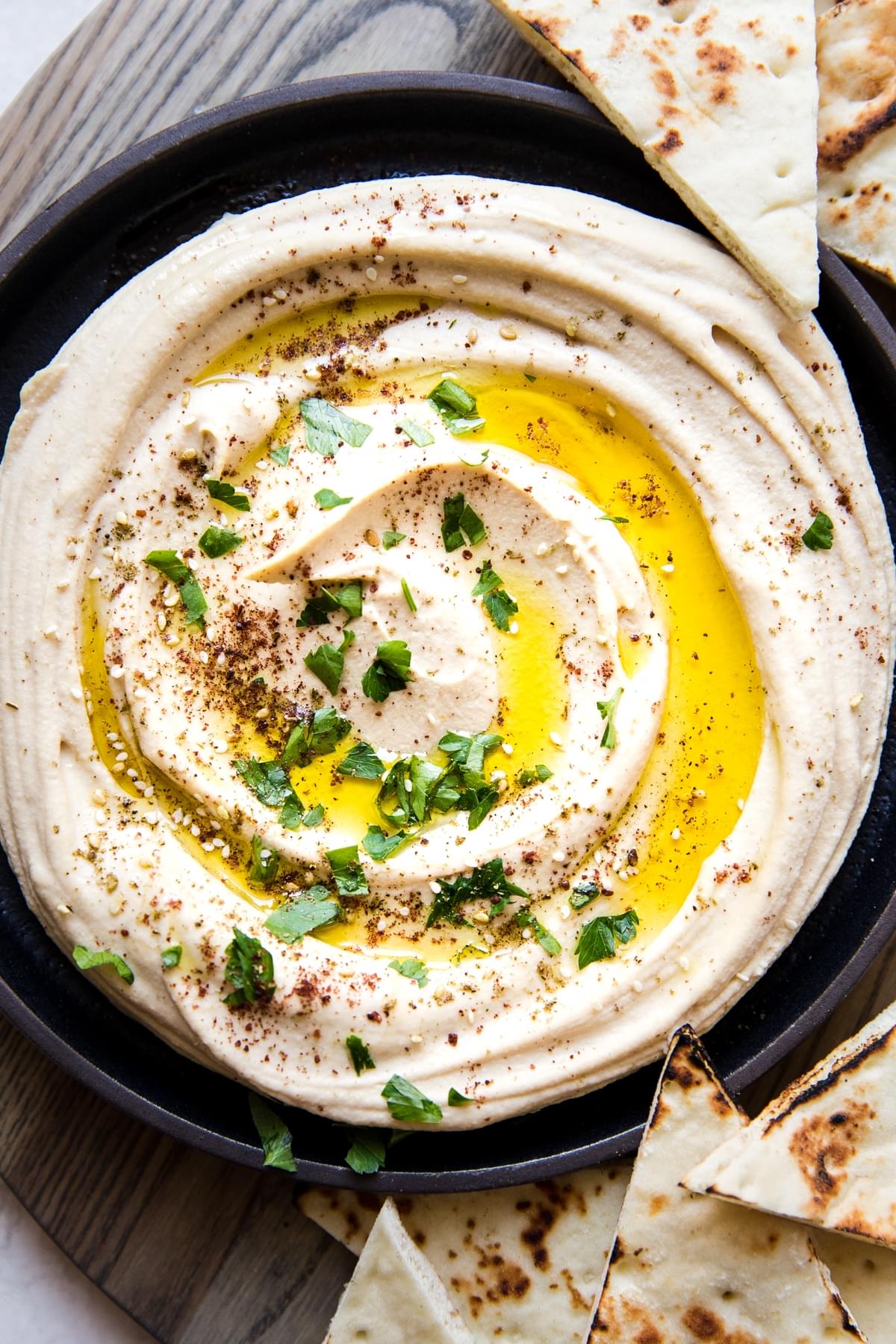classic creamy hummus with olive oil and parsley