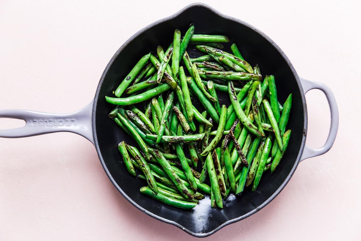 blistered green beans in a sauté pan
