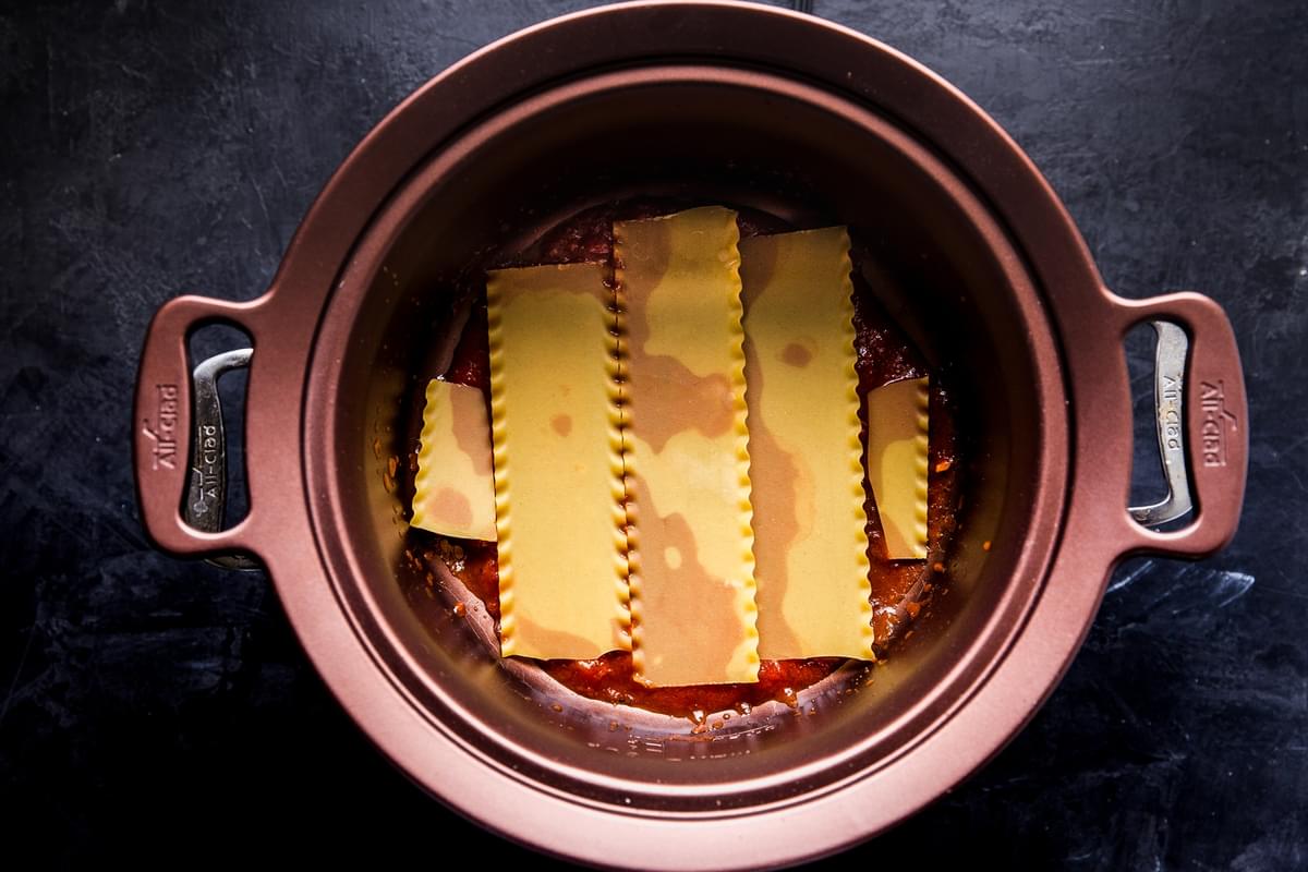 pasta sauce and lasagna noodles in a crockpot