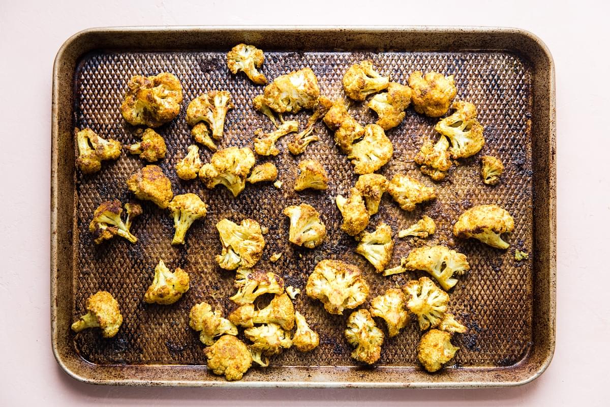 roasted curried cauliflower on a rimmed baking sheet