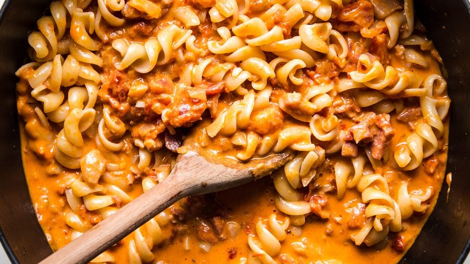 pasta added to easy homemade vodka sauce recipe in a soup pot