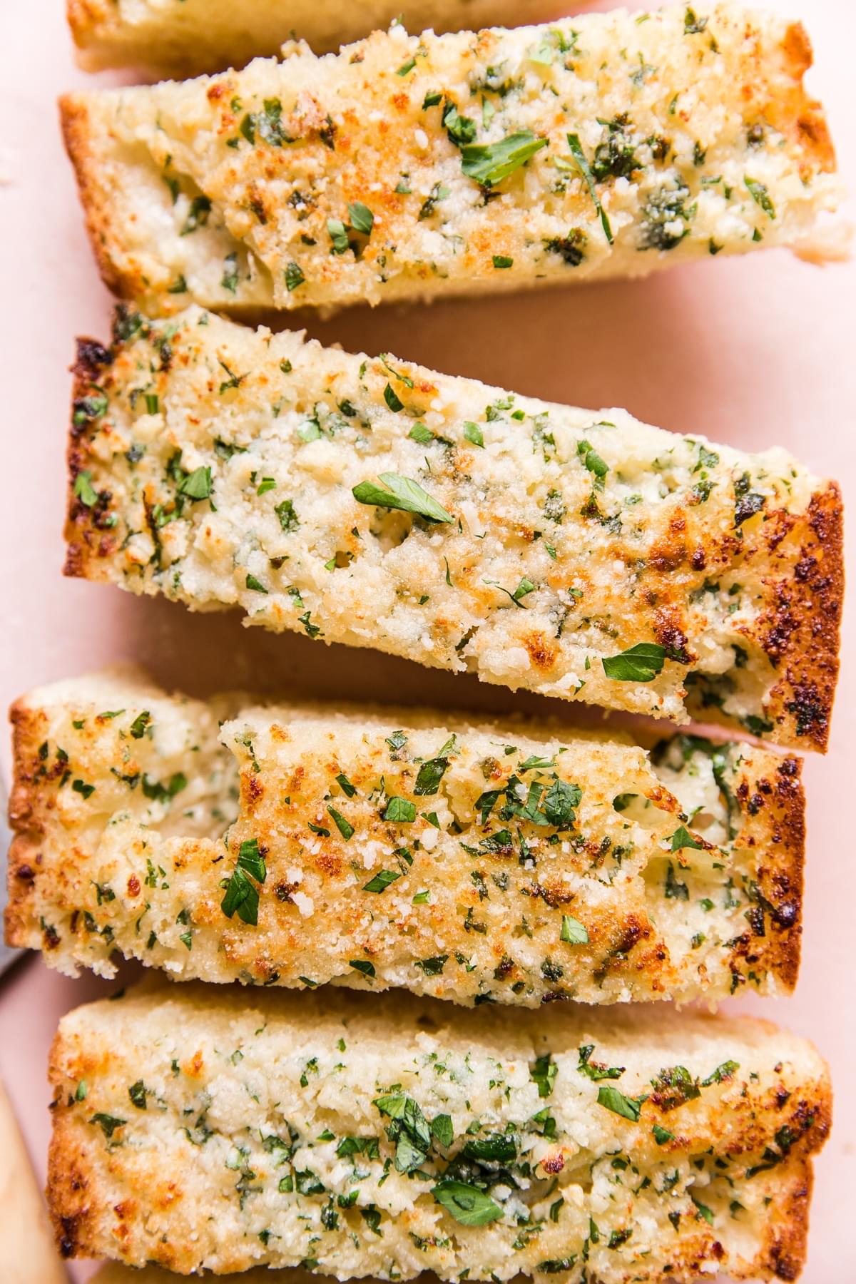closeup of cheesy garlic bread cut into slices