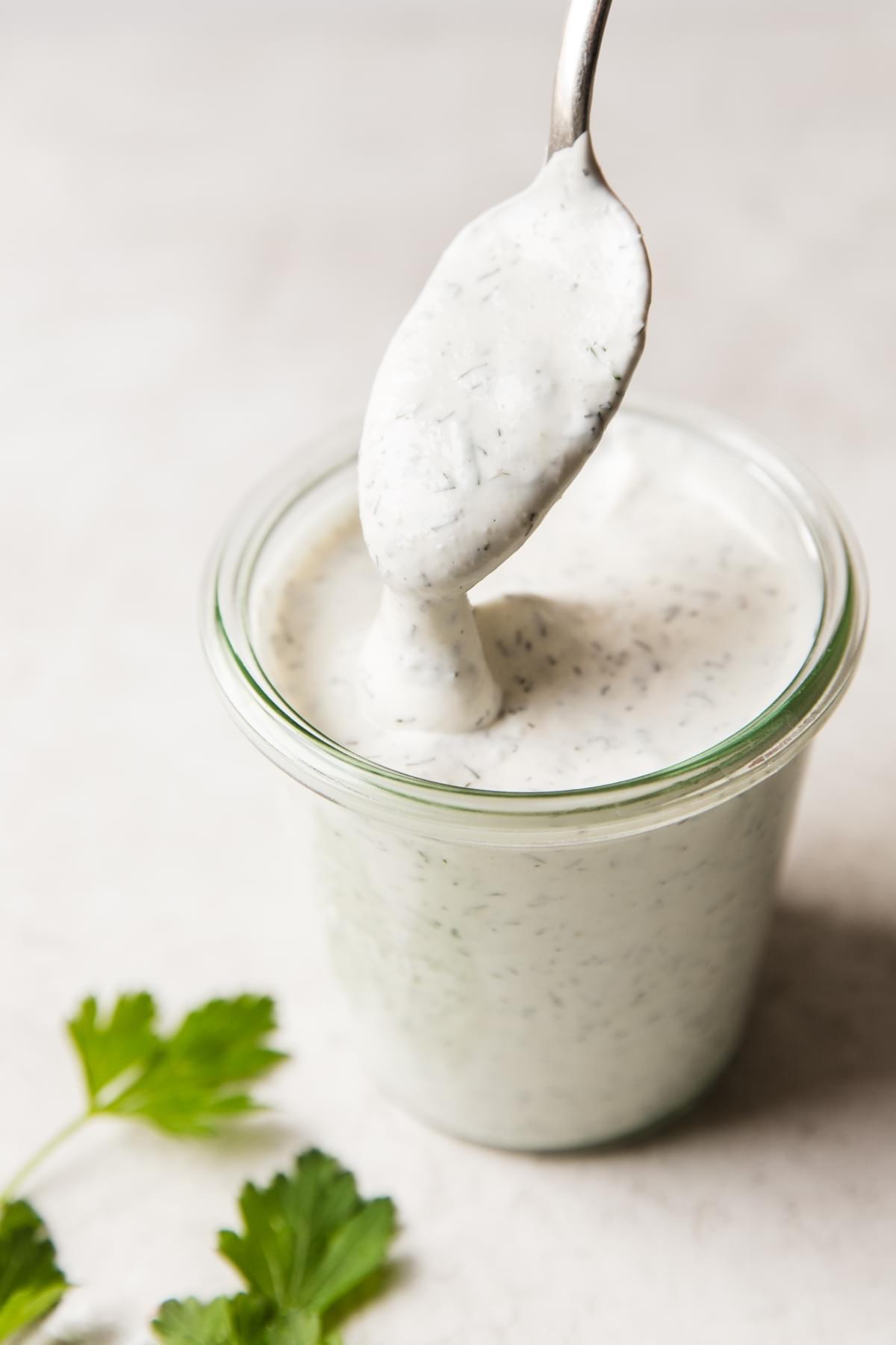 spoon dipped in jar of homemade ranch dressing