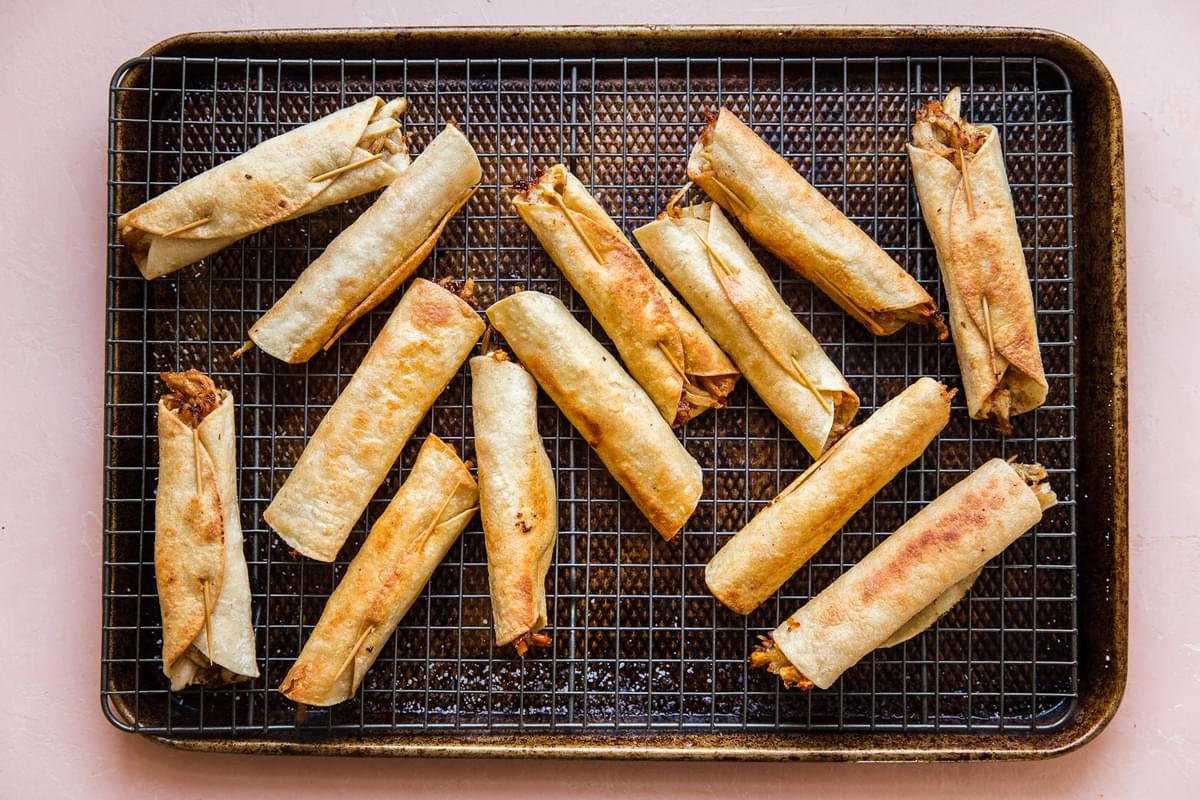 Homemade Chicken Taquitos on a cooling rack