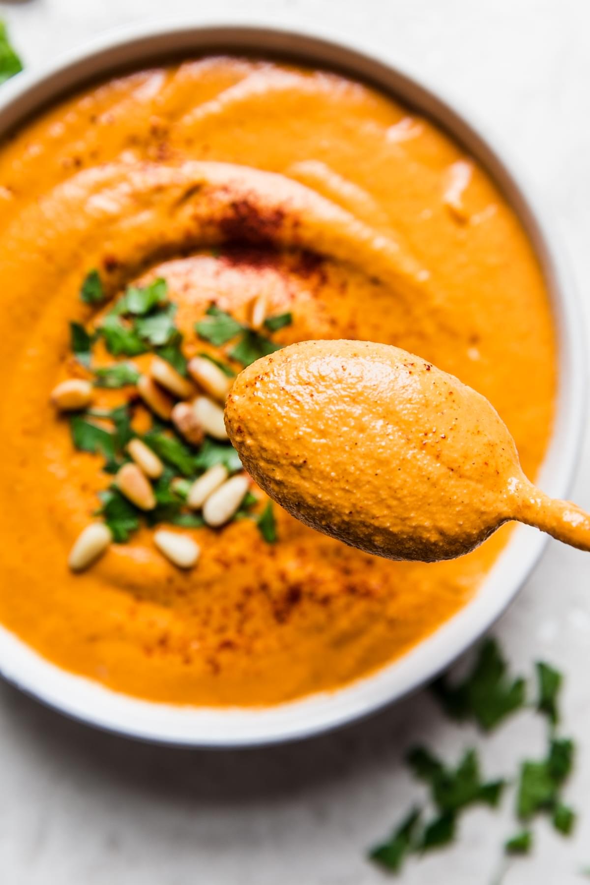 a spoonful of homemade romesco sauce over a bowl