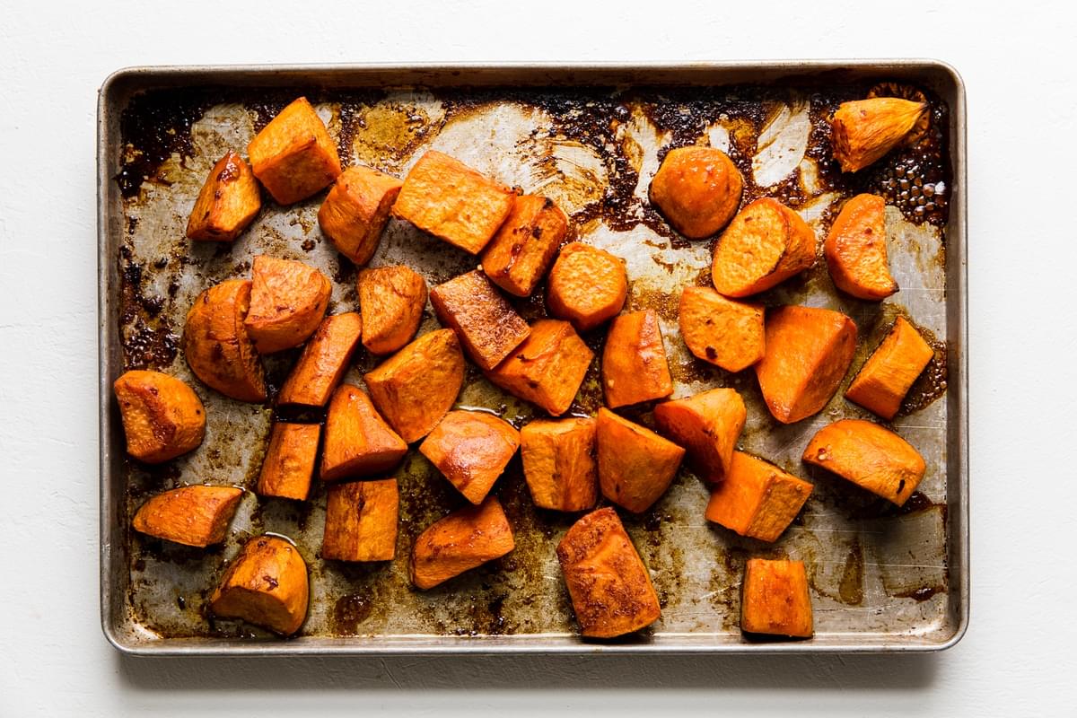 cubed Honey roasted sweet potatoes cooked on a baking sheet