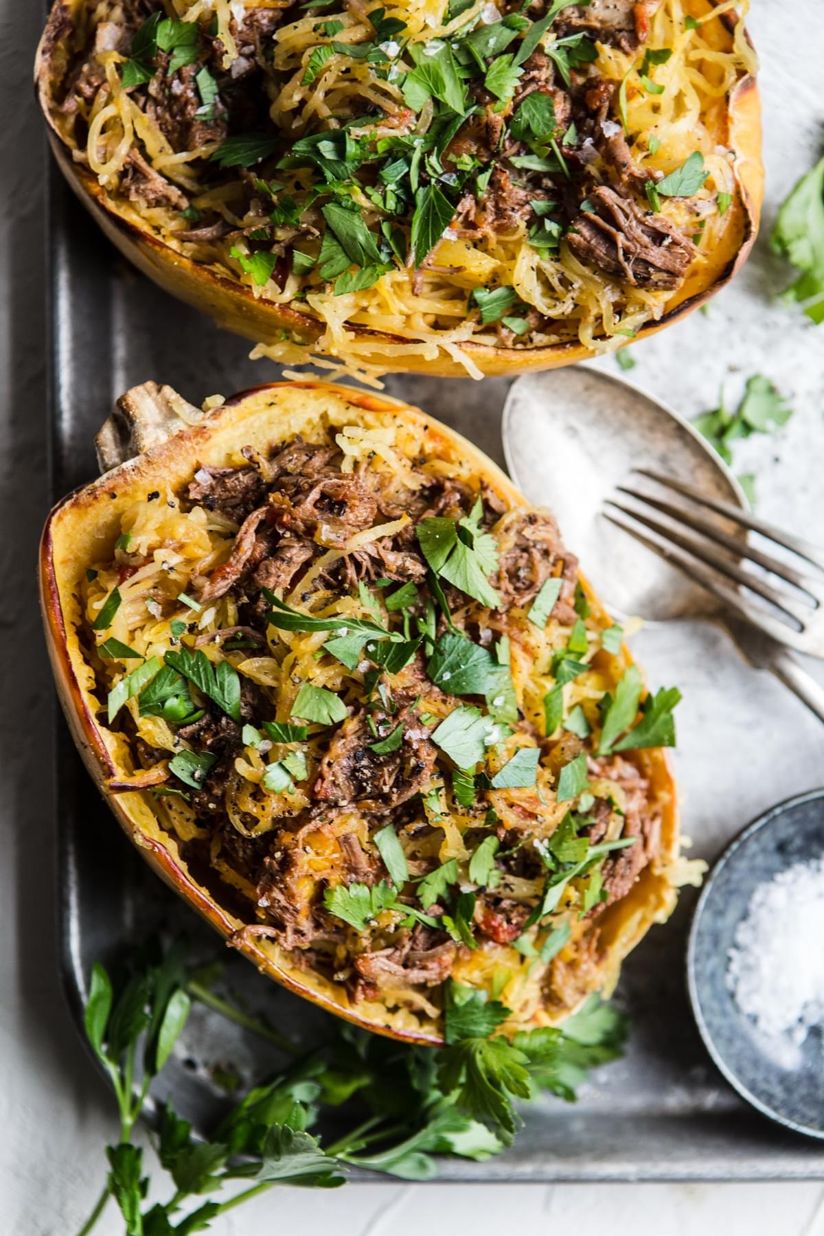 spaghetti squash cut in half topped with instant pot beef ragu