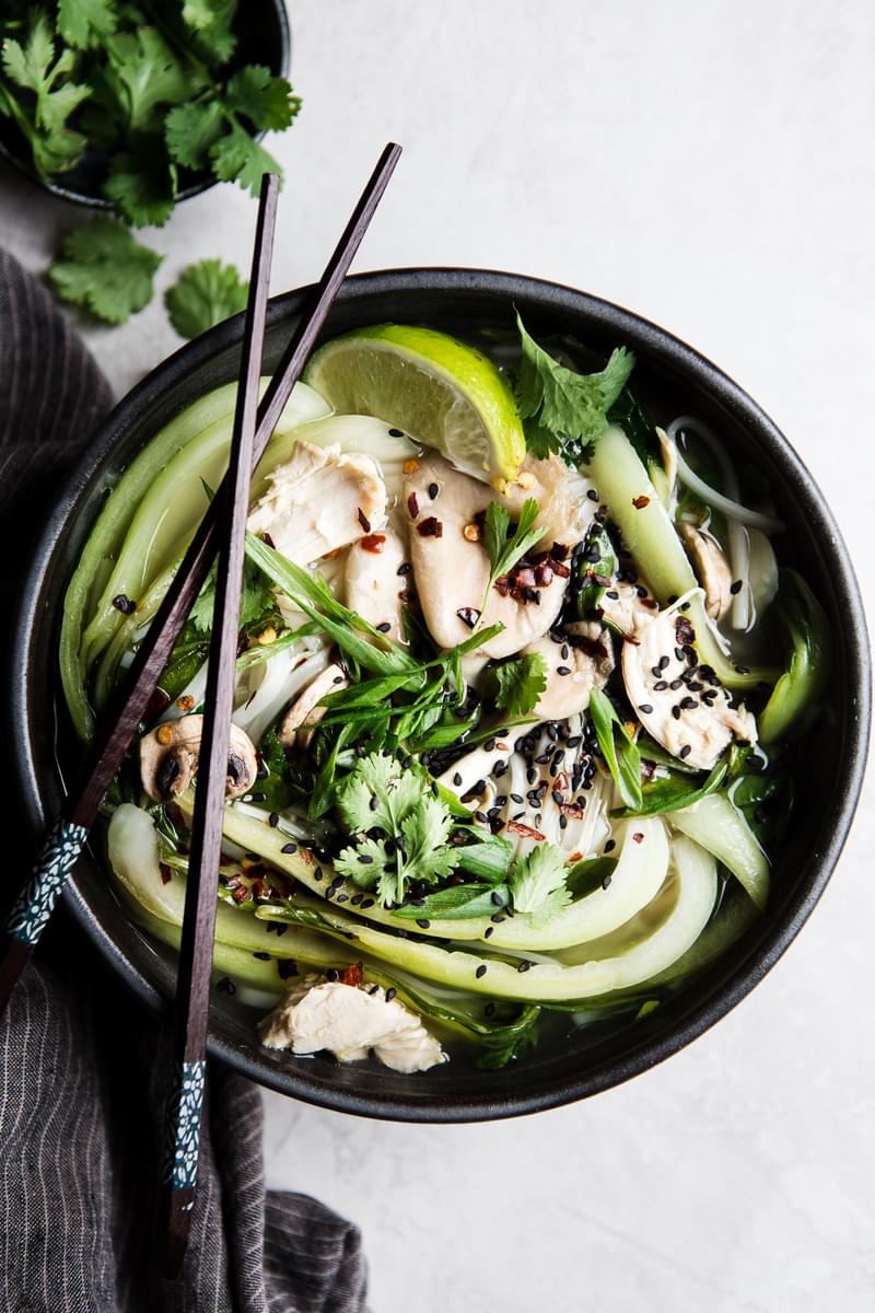leftover Turkey soup with rice noodles and bok choy in a bowl with chopsticks